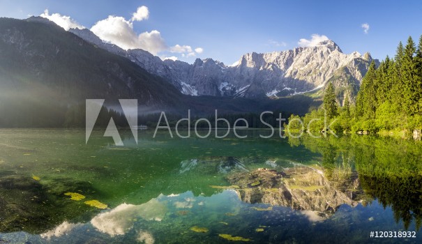 Picture of Alpine lake at dawn beautifully lit mountains